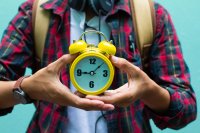 Student holding alarm clock