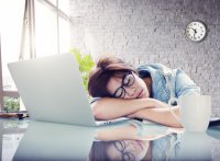 Young female asleep at desk