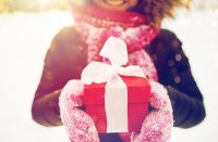 Smiling woman holding wrapped gift