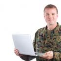 Military man holding a computer