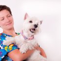 Vet assistant with cute dog in her arms