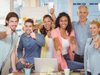 Image of employees giving a "thumbs up"